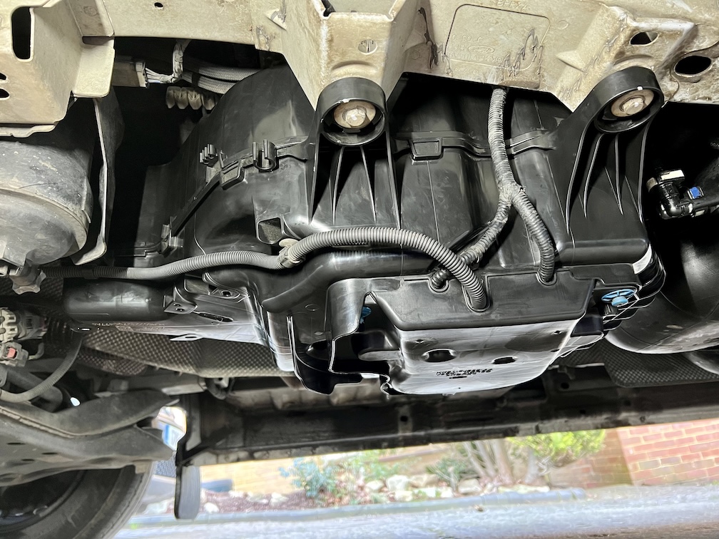 AdBlue SCR system tank and components viewed from underneath a diesel vehicle