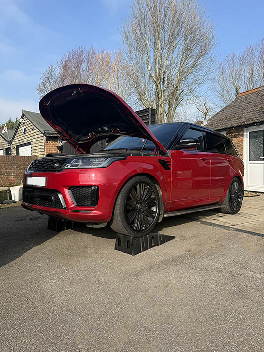 Red Range Rover Sport with bonnet open attended by JSM Diagnostics mobile technician